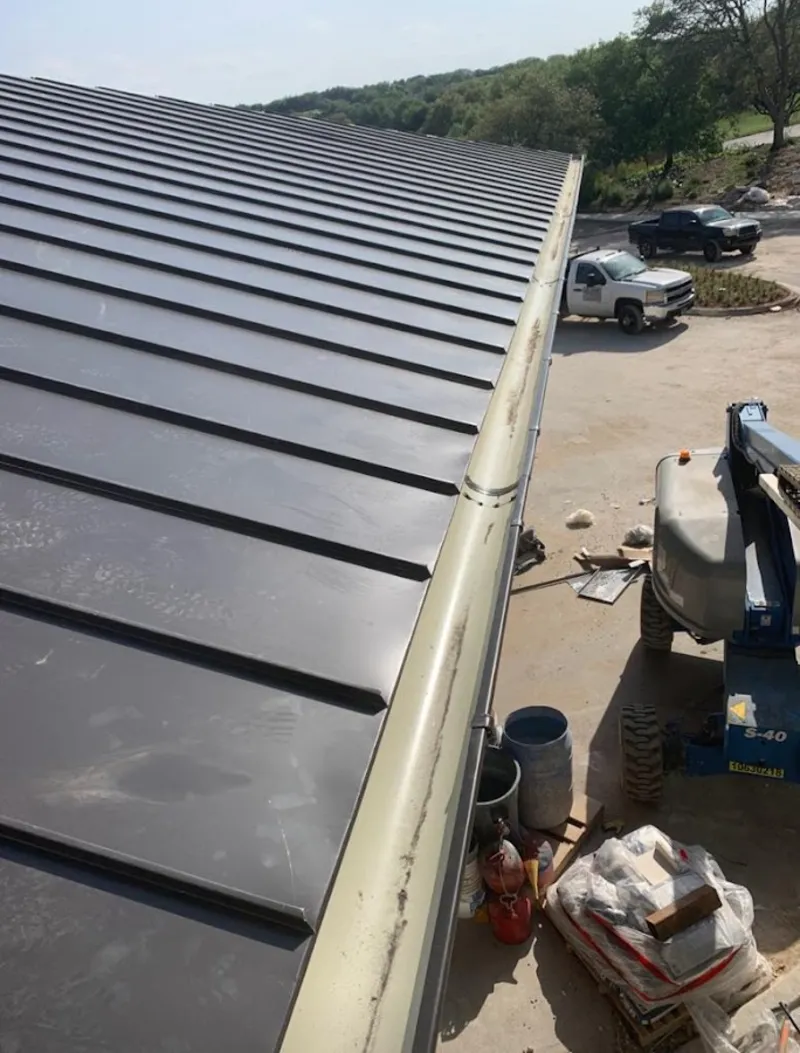 Standing seam panel and gutter detail on a metal roofing jobsite in South Gate